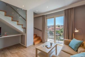 a living room with a staircase and a couch at Pansion Ermioni in Skala