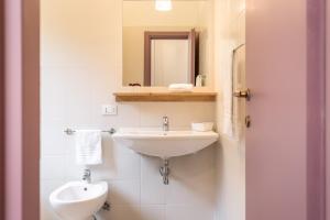 a bathroom with a sink and a toilet and a mirror at Antica Villa in Gaeta