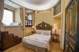 a bedroom with a large bed and a staircase at Royal Suite Trinità Dei Monti in Rome