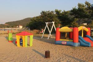 a group of playground equipment on a sandy beach at Garden Bungalow Valentina in Stavros