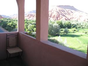 a window in a room with a view of a mountain at Auberge Des Jardins du Dades in Boumalne