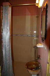 a bathroom with a sink and a shower at Auberge Des Jardins du Dades in Boumalne