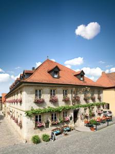 um grande edifício com flores ao lado em Gasthof Hotel Weinbau "Zum Goldenen Ochsen" em Sommerhausen