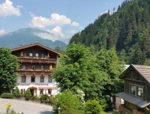 a large building in the middle of a mountain at Gasthof Hochsteg in Finkenberg