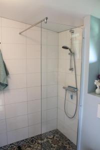 a shower with a glass door in a bathroom at Bed and Stay Amsterdam in Amsterdam