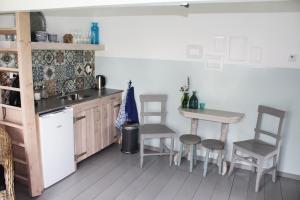 a kitchen with a table and chairs and a sink at Bed and Stay Amsterdam in Amsterdam