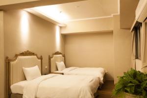 Llit o llits en una habitació de Chihpen Hotel Royal Kingdom