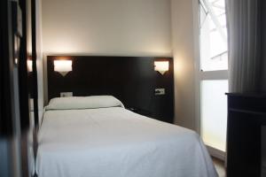 Łóżko lub łóżka w pokoju w obiekcie Hotel Irixo