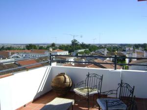 a balcony with two chairs and a vase on it at D'Iberica Alojamento in Évora
