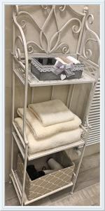 a towel rack with some towels on it at Lanterna Room&Breakfast in Carpi