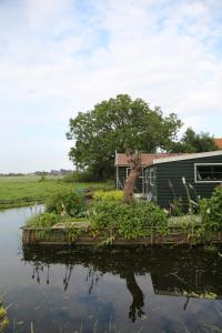 a house next to a body of water at Bed and Stay Amsterdam in Amsterdam