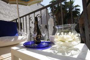 a bottle of champagne and a vase of flowers on a table at Residenza D'Epoca B&B Celeste in Caserta