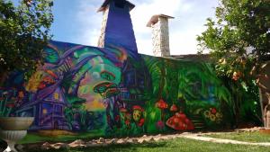 a mural painted on the side of a building at Natural Mystic Hostel in Costa da Caparica