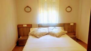 a bedroom with a bed with two pillows on it at Villa Salteri in Benidorm +14 photos