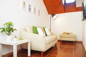 a living room with a couch and a table at Belém Apartment in Lisbon