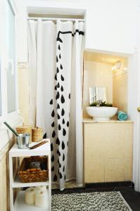 a bathroom with black and white curtains and a sink at Belém Apartment in Lisbon