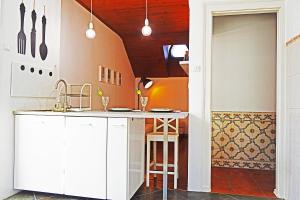 a kitchen with a sink and a counter top at Belém Apartment in Lisbon
