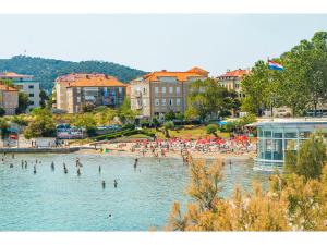 a group of people in the water at a beach at IDRO Studio Apartments directly at the beach in Split