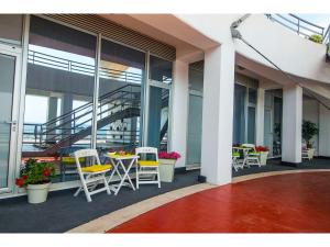 a balcony with chairs and tables on a building at IDRO Studio Apartments directly at the beach in Split