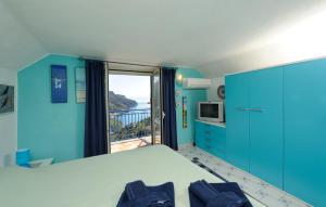 a blue bedroom with a bed and a balcony at BB Ravello Houses in Ravello