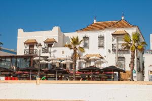 a large building with umbrellas on top of it at Hotel Playa de Regla in Chipiona