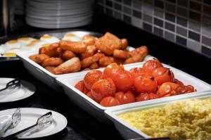 two trays of food with tomatoes and scrambled eggs at Avisford Park Hotel in Arundel