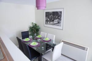a dining room with a glass table and chairs at East Village City Center Luxury Apartment in Liverpool