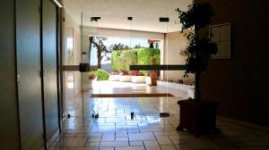 a hallway with a potted plant on a tile floor at Les Jardins de Villefranche in Villefranche-sur-Mer