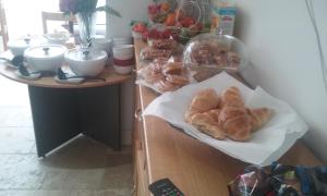 a table with croissants and other pastries on it at Jessamine House Hotel in Gravesend