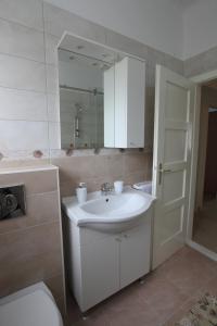 a bathroom with a sink and a toilet and a mirror at Apartman Seaside Paradise in Split