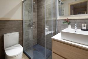 a bathroom with a shower and a toilet and a sink at Val de Ruda Luxe 50 by FeelFree Rentals in Baqueira-Beret +20 photos