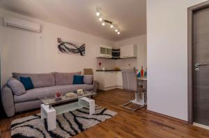 a living room with a couch and a table at Apartments Silvia in Zadar