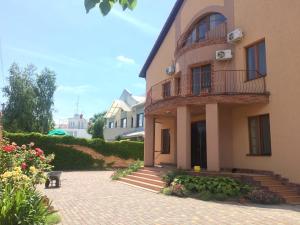 a large building with a balcony and a patio at Veranda Guest House in Chornomorsk
