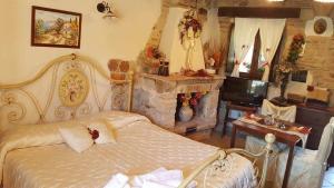 a bedroom with a bed and a stone fireplace at B&B La Casetta sul Lago in Colle di Tora