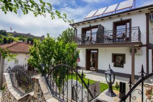 a house with a gate and a balcony at Apartments St Dimitrij in Ohrid