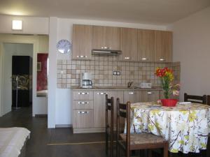 a kitchen with a table with a table cloth on it at Apartment One in Rab