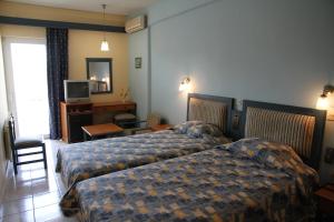 Postel nebo postele na pokoji v ubytování Astron Hotel