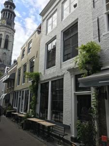 a street with a building with a clock tower at bednextdoor in Middelburg