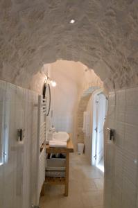 a bathroom with a sink and a toilet at Suite Curcuma in Alberobello