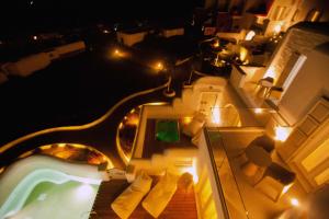 an aerial view of a swimming pool at night at Golden Sun Hotel in Stelida