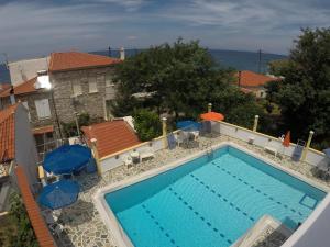 a swimming pool with a view of the ocean at Apartments Zafiria in Ágios Konstantínos