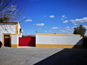 a yellow and white wall next to a building at Casa do Peso in Crato