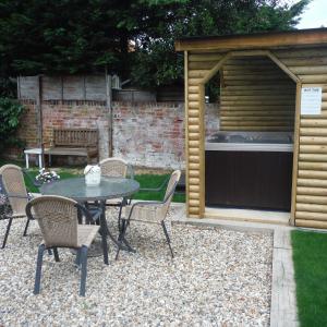 a patio with a table and chairs in a backyard at Little Parklands Apt2 in Sandown