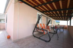 a porch with chairs and a table on a patio at Apartman Mirica Solin in Solin