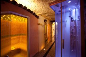 a bathroom with a shower and a walk in shower at Hotel Castello in Tignale