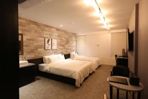 Postel nebo postele na pokoji v ubytování Le Idea Hotel Busan Station