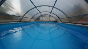 a pool of water in a metal building at Hotel Restaurant Stöckl in Deutsch Altenburg