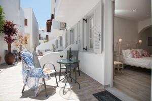 a balcony with a table and chairs on a building at Relax Studios in Naxos Chora