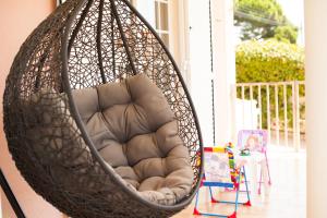 a swing hanging from a porch with a chair at Grace Villa in Aldeia de Juso