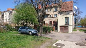 a car parked in front of a house at Spacious Klaipeda Apartment EV in Klaipėda